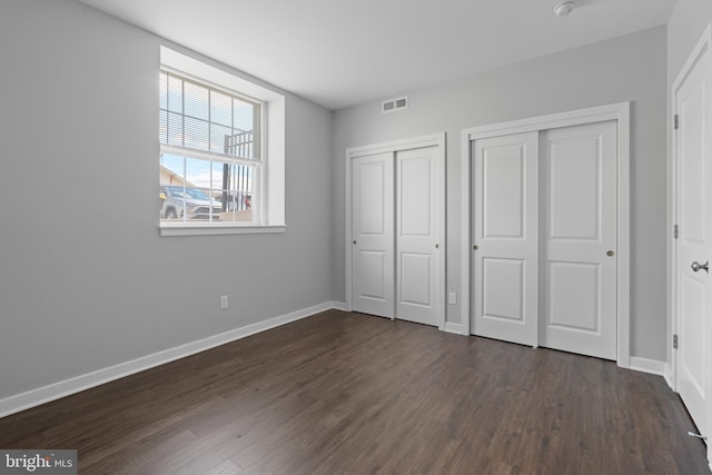 413 Jefferson St Unit 3, East Greenville, PA 18041 - unfurnished bedroom featuring two closets and dark wood-style floors