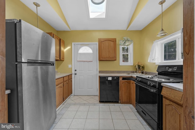 2704 N Tatnall St, Wilmington, DE 19802 - kitchen with black appliances, pendant lighting, healthy amount of natural light, and light tile patterned flooring