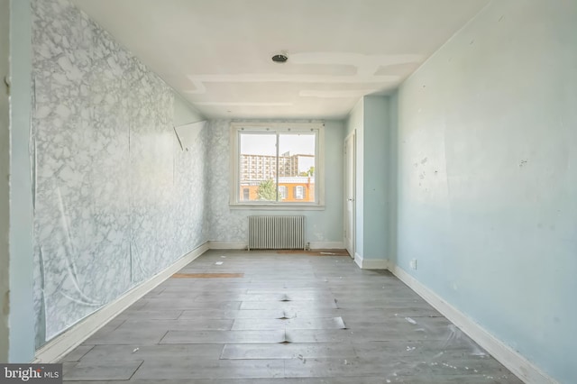 2704 N Tatnall St, Wilmington, DE 19802 - unfurnished room featuring radiator heating unit and wood finished floors