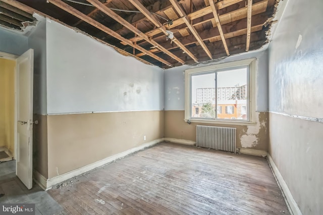 2704 N Tatnall St, Wilmington, DE 19802 - spare room featuring radiator and hardwood / wood-style floors