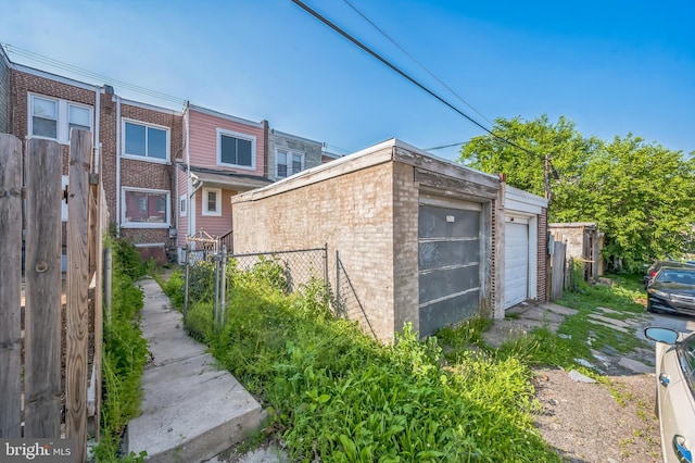 2704 N Tatnall St, Wilmington, DE 19802 - view of side of home with an outdoor structure, a garage, and brick siding
