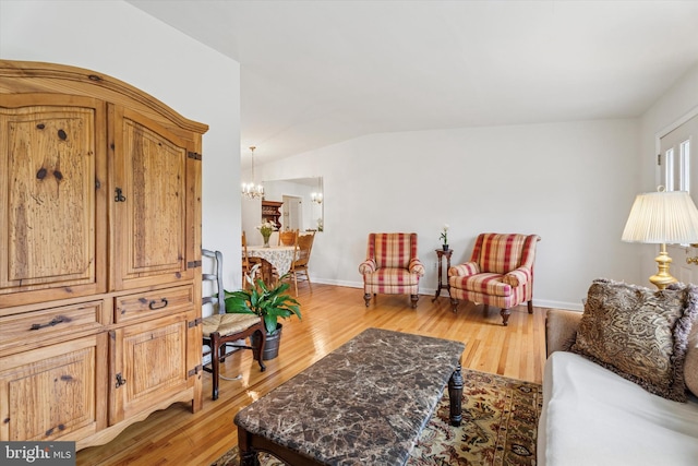 575 Wanamaker Rd, Jenkintown, PA 19046 - living room with light wood-style flooring, a chandelier, and vaulted ceiling