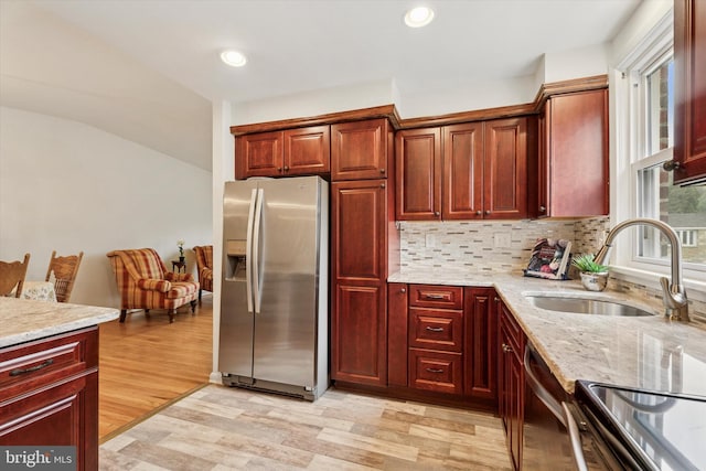 575 Wanamaker Rd, Jenkintown, PA 19046 - kitchen featuring stainless steel appliances, reddish brown cabinets, light wood-style floors, light stone countertops, and recessed lighting
