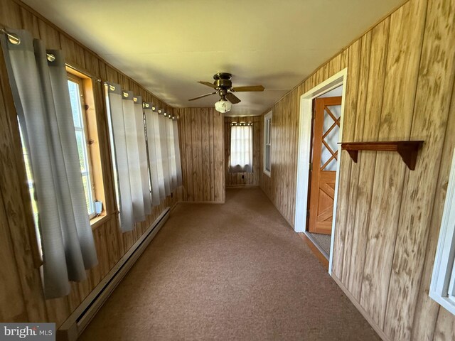 11 Gray Ridge Ln, Berkeley Springs, WV 25411 - spare room featuring a baseboard radiator, carpet, ceiling fan, and wooden walls