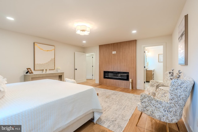 5303 Rolling Rd, Springfield, VA 22151 - bedroom featuring recessed lighting, a large fireplace, and light wood-type flooring