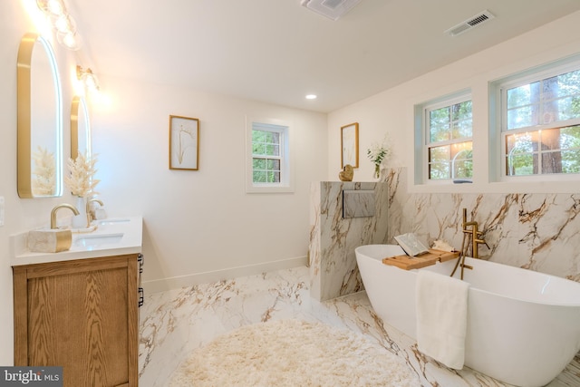 5303 Rolling Rd, Springfield, VA 22151 - bathroom featuring double vanity, a freestanding tub, and marble finish flooring
