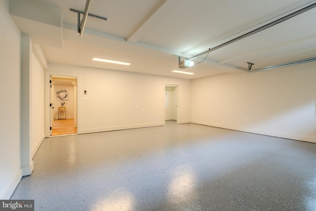 5303 Rolling Rd, Springfield, VA 22151 - garage with a garage door opener and baseboards