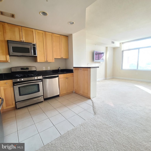 3600 S Glebe Rd Unit 330W, Arlington, VA 22202 - kitchen with stainless steel appliances, light carpet, light tile patterned floors, recessed lighting, and dark countertops