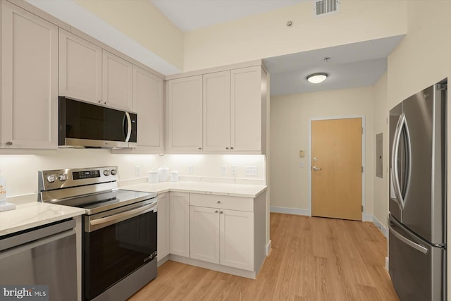 910 M St NW Unit 116, Washington, DC 20001 - kitchen with appliances with stainless steel finishes, light wood-style floors, and light stone countertops