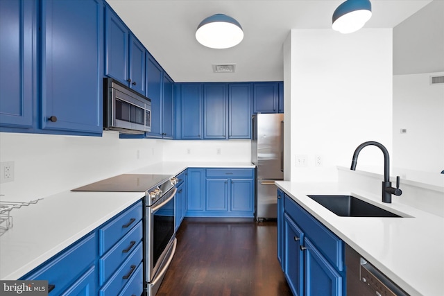 105 Christina Lndg Unit 1402, Wilmington, DE 19801 - kitchen with appliances with stainless steel finishes, blue cabinets, dark wood-type flooring, and light countertops