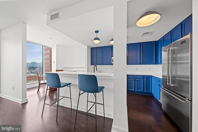 105 Christina Lndg Unit 1402, Wilmington, DE 19801 - kitchen featuring high end fridge, blue cabinetry, and a breakfast bar area