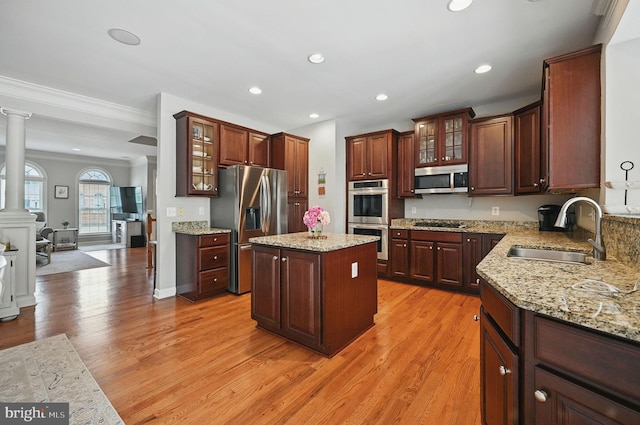 25369 Peaceful Ter, Aldie, VA 20105 - kitchen with stainless steel appliances, light wood-style floors, glass insert cabinets, crown molding, and recessed lighting