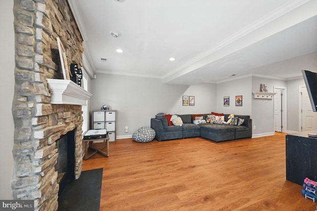25369 Peaceful Ter, Aldie, VA 20105 - living area featuring light wood-style floors, crown molding, recessed lighting, and a stone fireplace