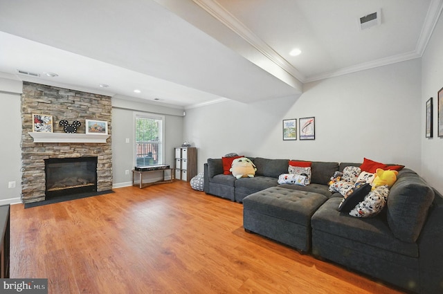 25369 Peaceful Ter, Aldie, VA 20105 - living area featuring crown molding, wood finished floors, a stone fireplace, and recessed lighting
