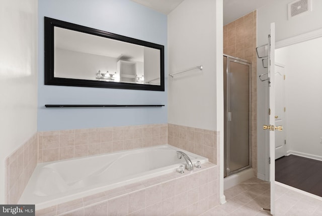 9710 Handerson Pl Unit 1, Manassas Park, VA 20111 - bathroom featuring a garden tub, a stall shower, and tile patterned flooring