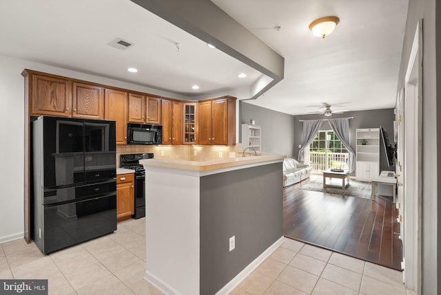 9710 Handerson Pl Unit 1, Manassas Park, VA 20111 - kitchen with black appliances, brown cabinets, glass insert cabinets, tasteful backsplash, and a ceiling fan