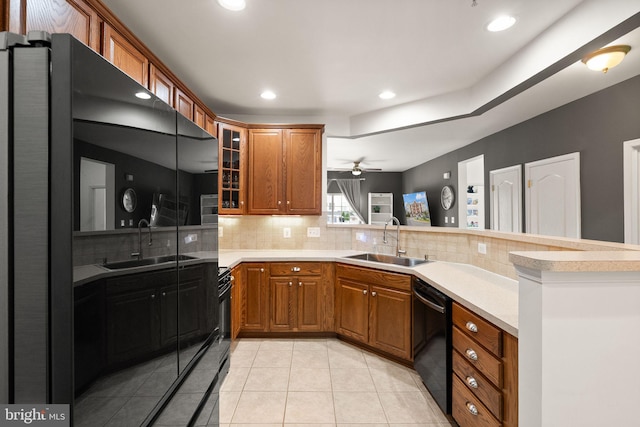 9710 Handerson Pl Unit 1, Manassas Park, VA 20111 - kitchen featuring black dishwasher, a peninsula, brown cabinetry, backsplash, and recessed lighting