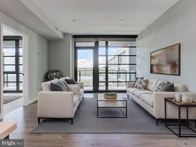 1300 4th St SE Unit 908, Washington, DC 20003 - living area with expansive windows, healthy amount of natural light, and wood finished floors