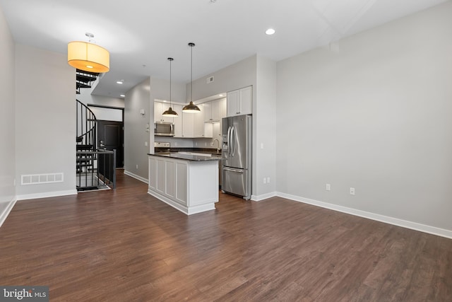 413 Jefferson St Unit 5, East Greenville, PA 18041 - kitchen featuring appliances with stainless steel finishes, dark countertops, white cabinets, dark wood-style flooring, and hanging light fixtures