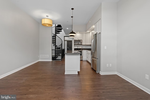 413 Jefferson St Unit 5, East Greenville, PA 18041 - kitchen with appliances with stainless steel finishes, white cabinets, dark wood-style flooring, pendant lighting, and a kitchen island