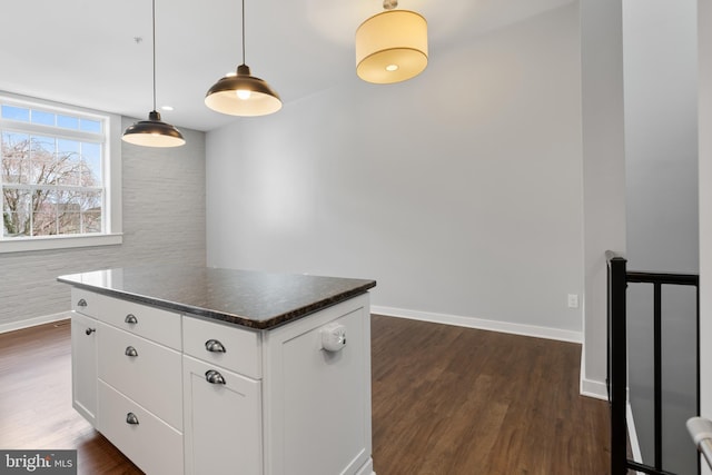 413 Jefferson St Unit 5, East Greenville, PA 18041 - kitchen with dark wood finished floors, dark countertops, white cabinetry, a center island, and pendant lighting