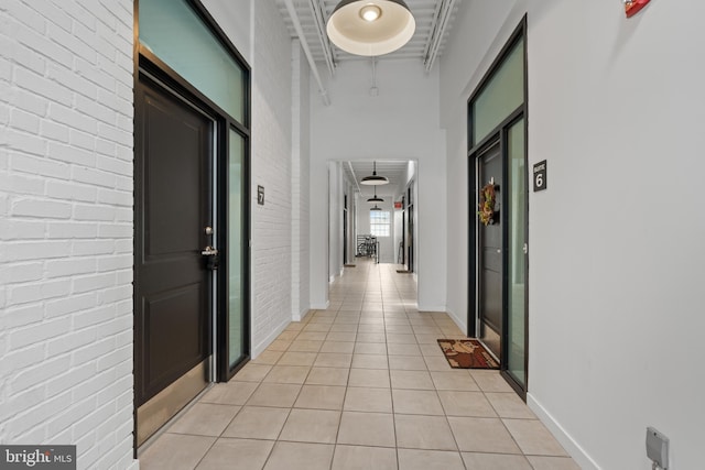 413 Jefferson St Unit 5, East Greenville, PA 18041 - corridor featuring light tile patterned floors, brick wall, and a high ceiling