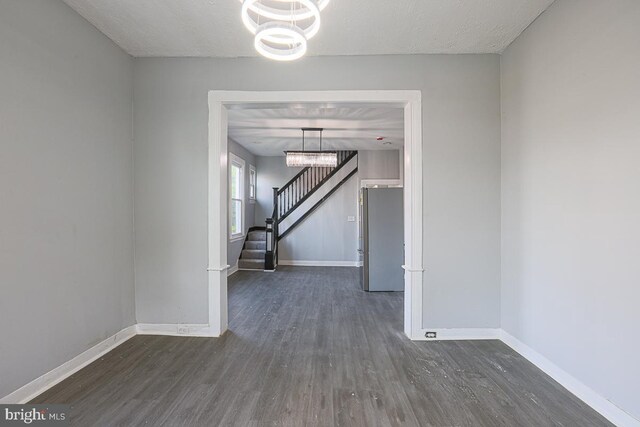 604 E 31st St, Baltimore, MD 21218 - spare room with a chandelier, wood finished floors, and stairway