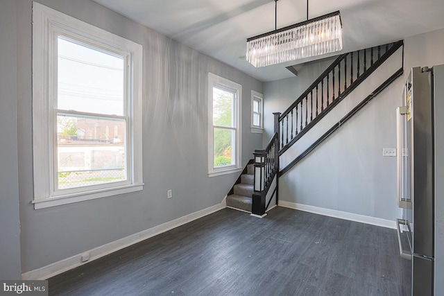 604 E 31st St, Baltimore, MD 21218 - foyer with dark wood finished floors, stairway, and a chandelier