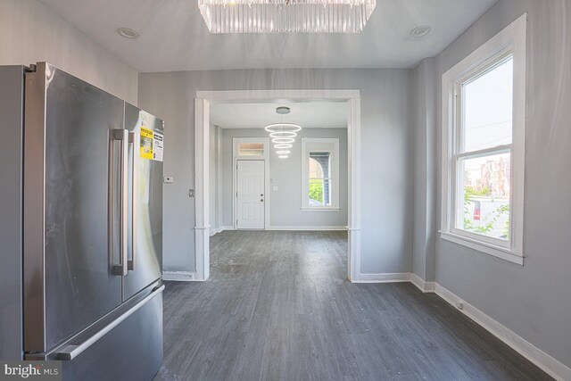 604 E 31st St, Baltimore, MD 21218 - unfurnished dining area with dark wood-style flooring, plenty of natural light, and a chandelier