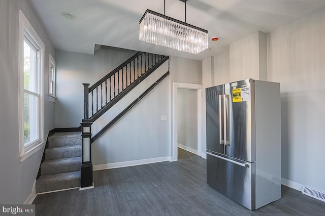 604 E 31st St, Baltimore, MD 21218 - staircase featuring wood finished floors and a chandelier