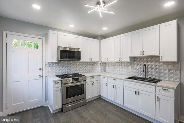 604 E 31st St, Baltimore, MD 21218 - kitchen with stainless steel appliances, light countertops, white cabinets, tasteful backsplash, and recessed lighting