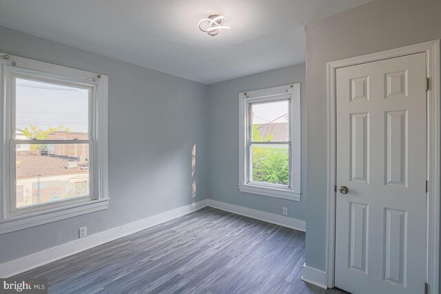604 E 31st St, Baltimore, MD 21218 - spare room with baseboards and dark wood finished floors
