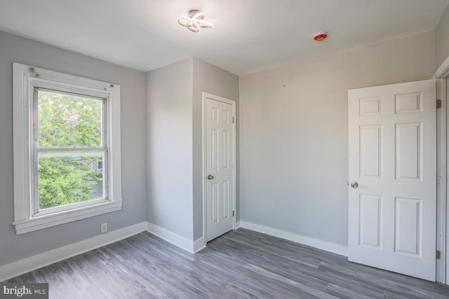 604 E 31st St, Baltimore, MD 21218 - unfurnished bedroom with baseboards and wood finished floors