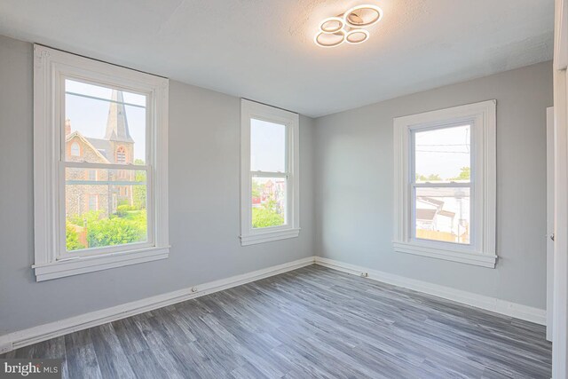 604 E 31st St, Baltimore, MD 21218 - empty room with wood finished floors and plenty of natural light
