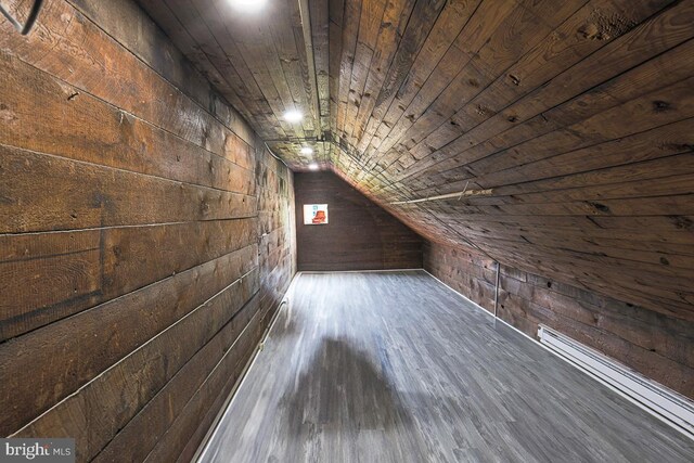 604 E 31st St, Baltimore, MD 21218 - additional living space with wood walls, a baseboard heating unit, vaulted ceiling, wood finished floors, and wood ceiling