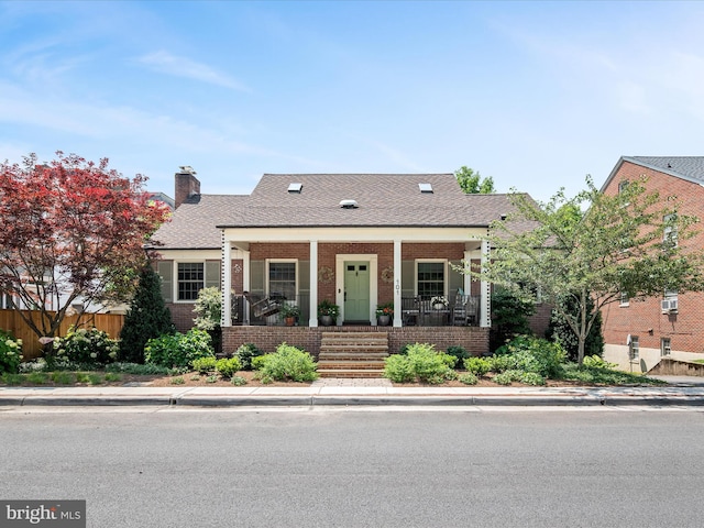 101 Morgan St, Winchester, VA 22601 - view of front of house featuring brick siding, a porch, a chimney, and a shingled roof