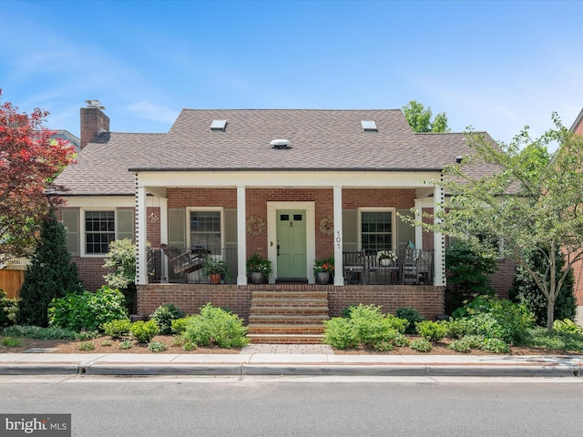 101 Morgan St, Winchester, VA 22601 - view of front of home featuring brick siding, a porch, a chimney, and roof with shingles