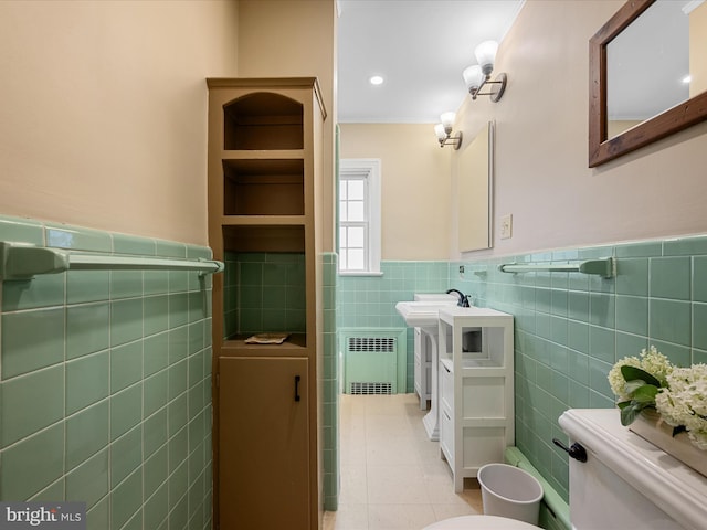 101 Morgan St, Winchester, VA 22601 - bathroom with tile walls, a wainscoted wall, tile patterned floors, radiator heating unit, and vanity