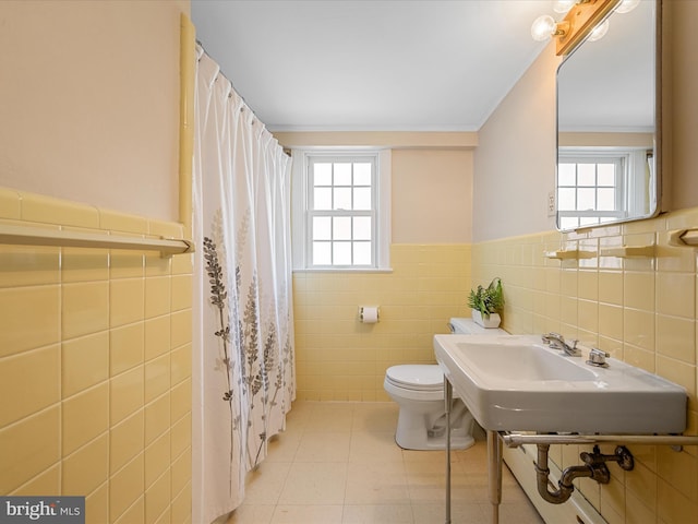 101 Morgan St, Winchester, VA 22601 - full bathroom with tile walls, healthy amount of natural light, wainscoting, tile patterned floors, and crown molding