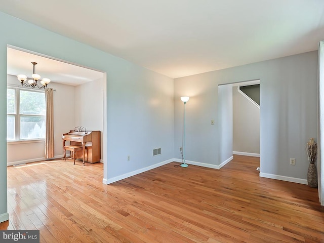 1035 Deerfield Cir, Perkasie, PA 18944 - unfurnished room with light wood-type flooring and a chandelier