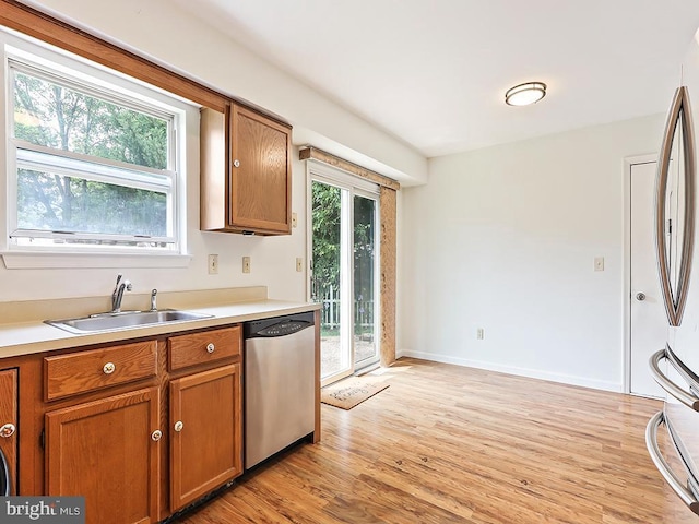 1035 Deerfield Cir, Perkasie, PA 18944 - kitchen with appliances with stainless steel finishes, brown cabinetry, light wood-style floors, and light countertops