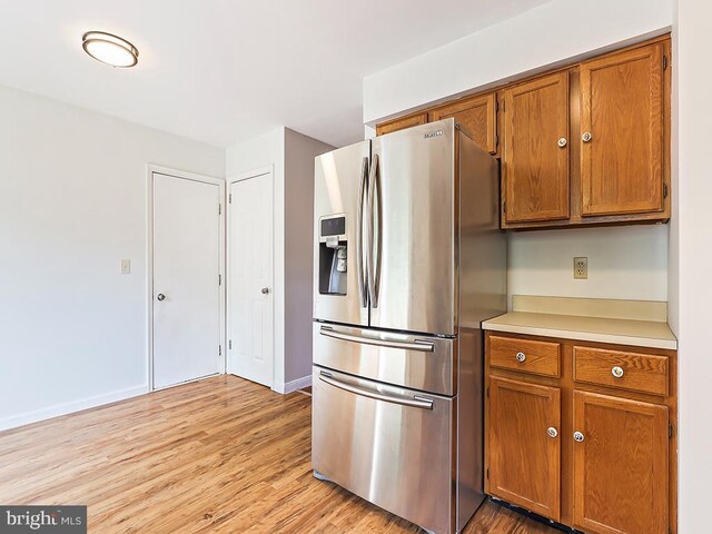 1035 Deerfield Cir, Perkasie, PA 18944 - kitchen featuring stainless steel refrigerator with ice dispenser, brown cabinets, light wood-type flooring, and light countertops