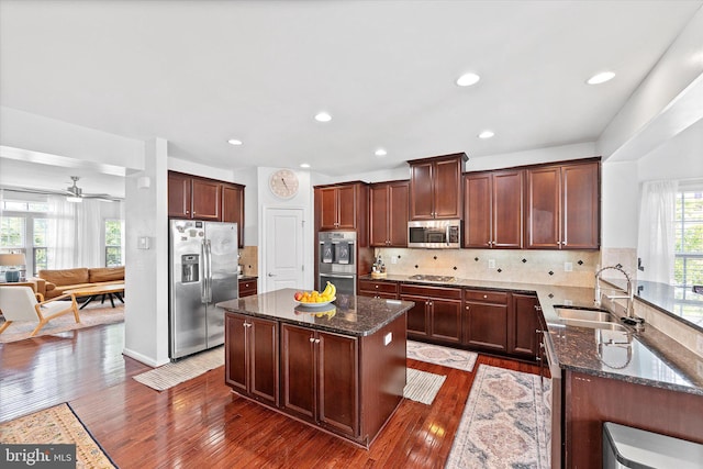 25672 Azalea Garden Ter, Aldie, VA 20105 - kitchen featuring stainless steel appliances, dark stone countertops, dark wood finished floors, a ceiling fan, and recessed lighting