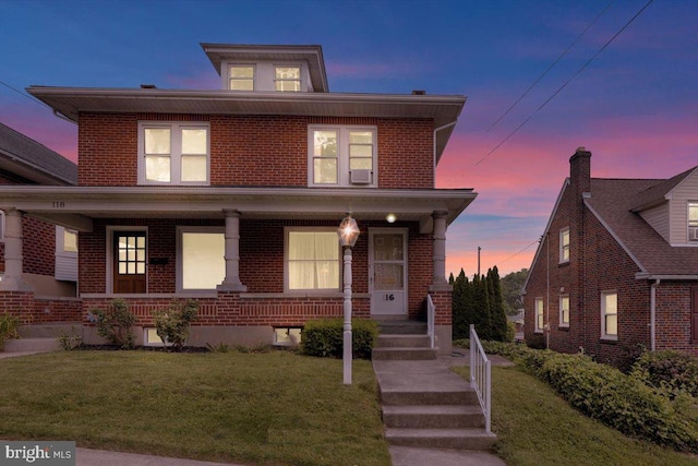 116 Chestnut St, Reading, PA 19607 - american foursquare style home featuring covered porch, brick siding, and a front lawn