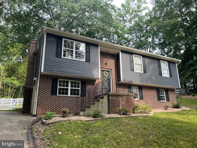 35904 Army Navy Dr, Mechanicsville, MD 20659 - view of front of home with brick siding, a chimney, and driveway