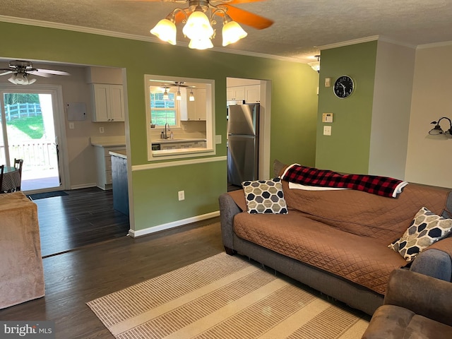 35904 Army Navy Dr, Mechanicsville, MD 20659 - living area with ceiling fan, dark wood-style floors, crown molding, and a textured ceiling