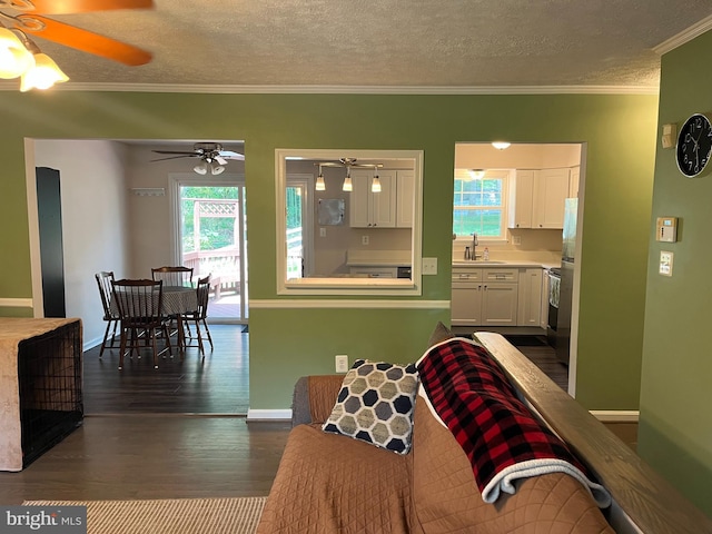 35904 Army Navy Dr, Mechanicsville, MD 20659 - living area featuring a textured ceiling, ceiling fan, healthy amount of natural light, dark wood finished floors, and crown molding
