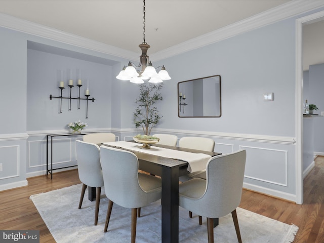 1473 Northern Neck Dr, Vienna, VA 22182 - dining room with a chandelier, ornamental molding, wainscoting, wood finished floors, and a decorative wall