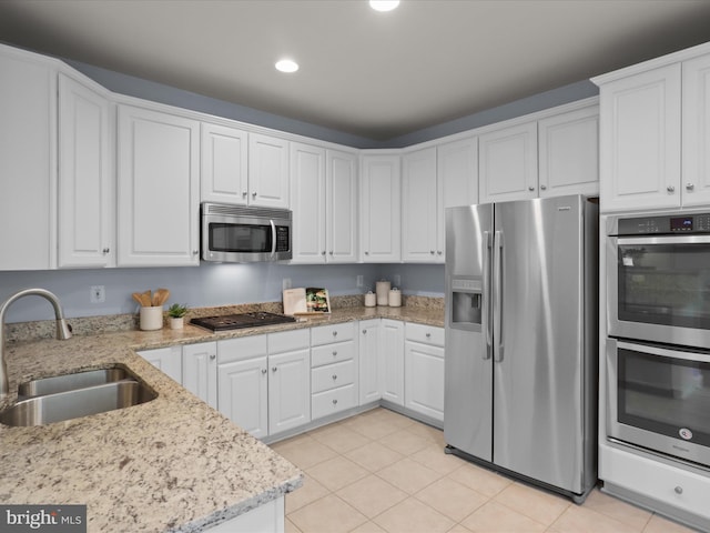 1473 Northern Neck Dr, Vienna, VA 22182 - kitchen featuring stainless steel appliances, white cabinets, recessed lighting, light tile patterned flooring, and light stone counters