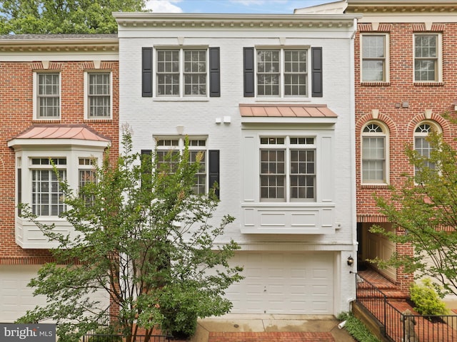 1473 Northern Neck Dr, Vienna, VA 22182 - view of front of property featuring an attached garage, a standing seam roof, and brick siding